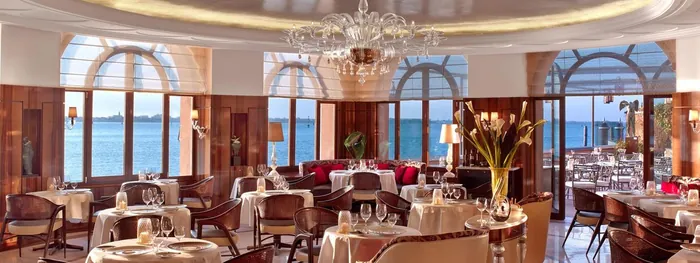 Hotel Cipriani Oro Restaurant interior with Murano chandelier and lagoon windows