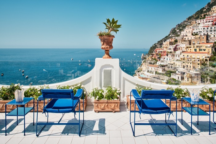 Le Sirenuse terrace with blue chairs overlooking Positano
