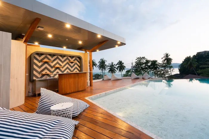 Panwaburi Resort rooftop infinity pool and bar overlooking the Andaman Sea at sunset