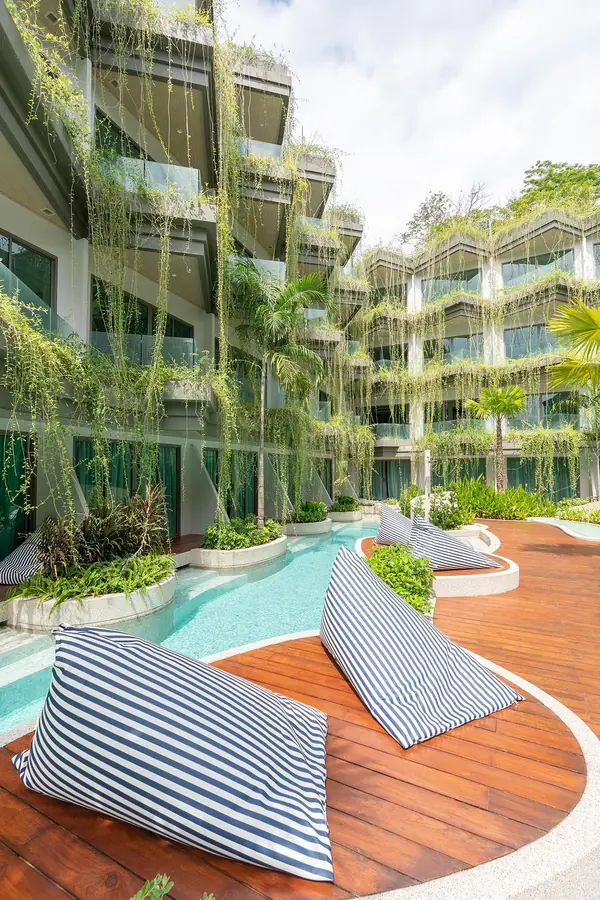 Panwaburi Resort Phuket poolside lounge with bean bag chairs and lush hanging greenery